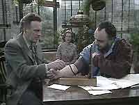 Awkward patient: Doctor Martel (Bernard Horsfall) treats market gardener George Trenett (John Rhys-Davies), while Mrs Trenett (Shirley Dixon) watches on.