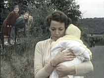 Betty Ridge (Norma Streader) tries to ignore three taunting children (Angela Porter, Emma Fox and Deborah Tullick).