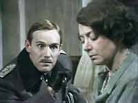 Standartenführer Grunwald (Clive Francis) tries to persuade Betty Ridge (Norma Streader) to give up custody of her son.